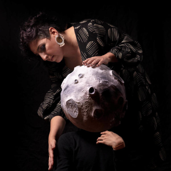 Ayelet Rose Gottlieb in a black and white dress holding a moon