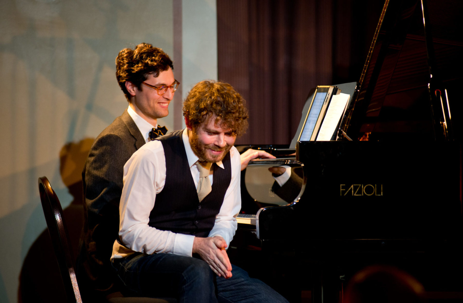 Gabriel Kahane & Timo Andres sitting at the same piano smiling