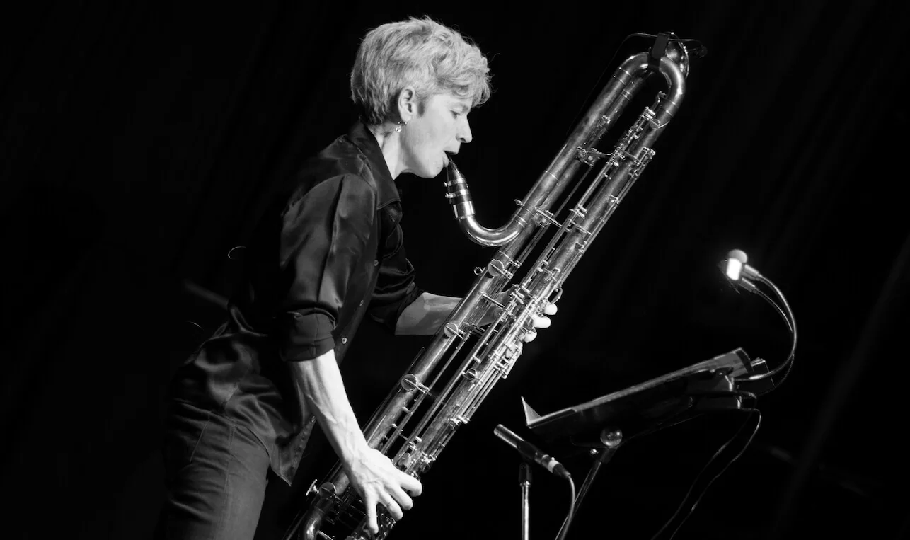 Black and white photo of Lori Freedman getting ready to blow the clarinet