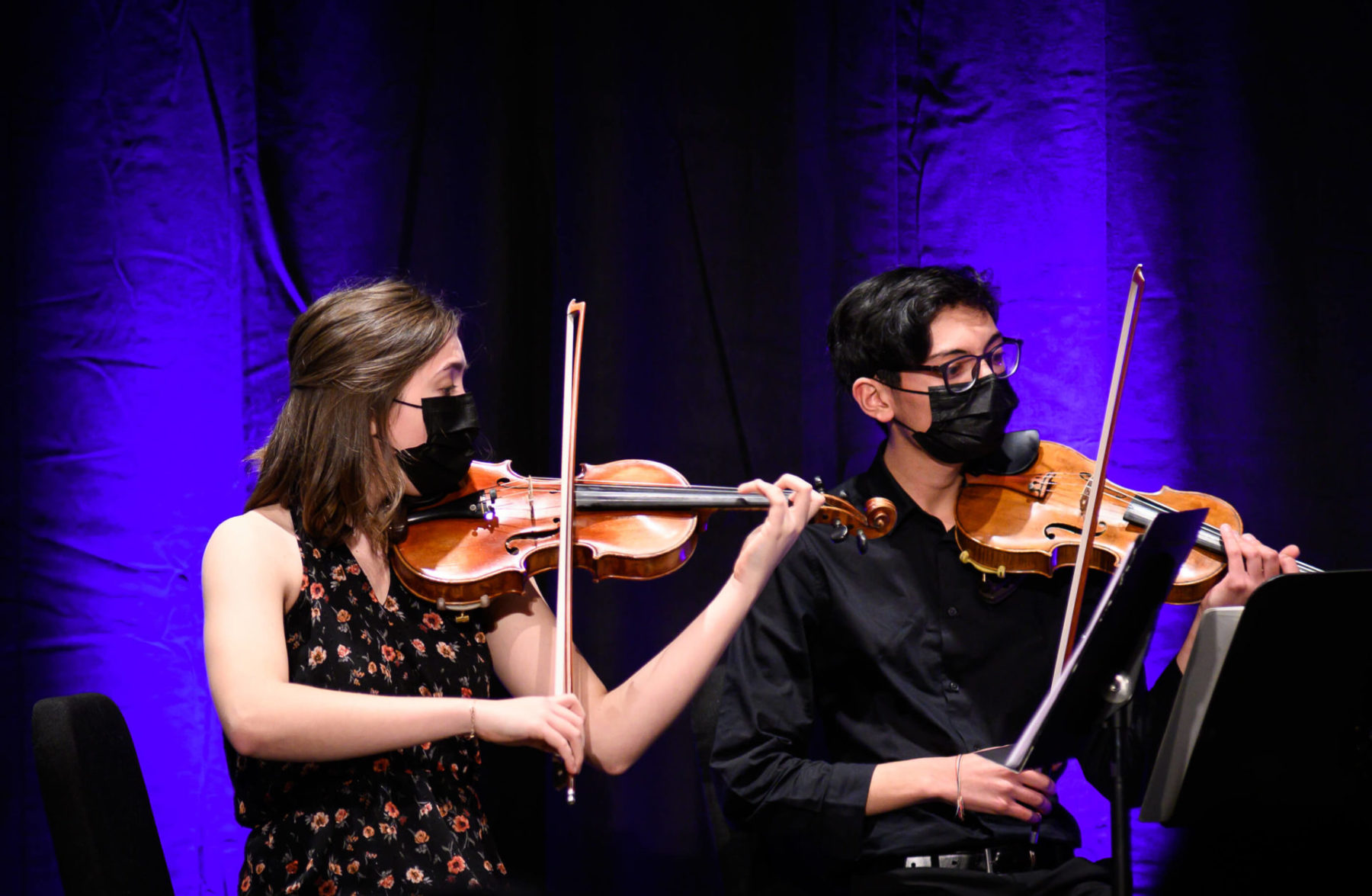 Close up of two members of the Sequoia Quartet performing on their violins