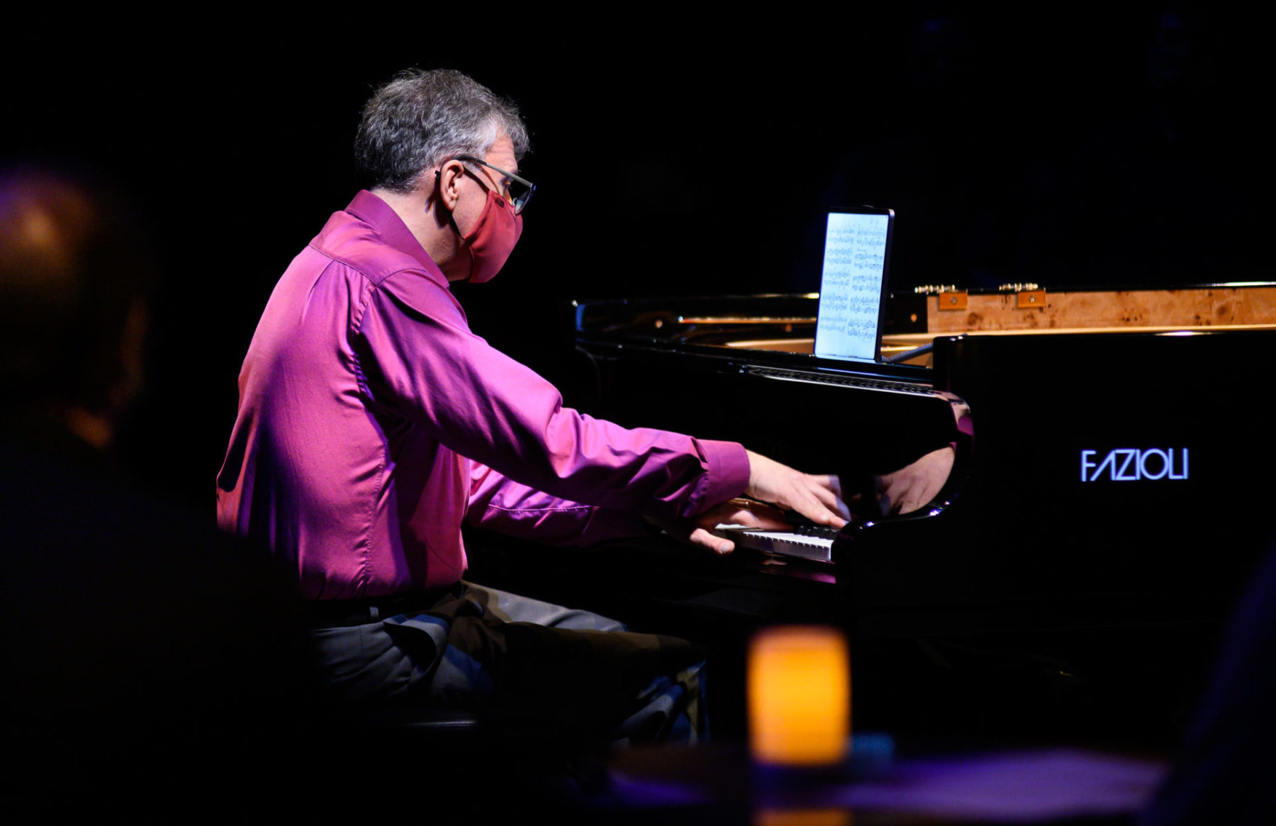 A close up of Corey Hamm playing the piano at the Roundhouse