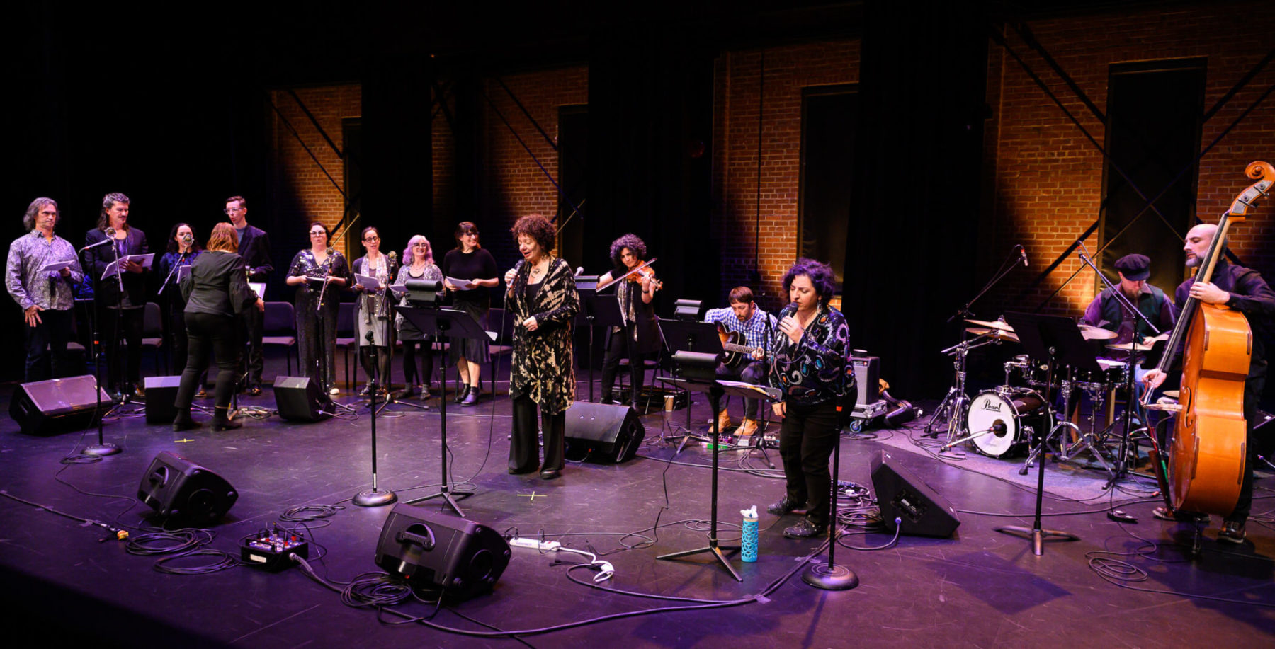 Wide shot of all performers in the concert, with Jay Clayton in the centre