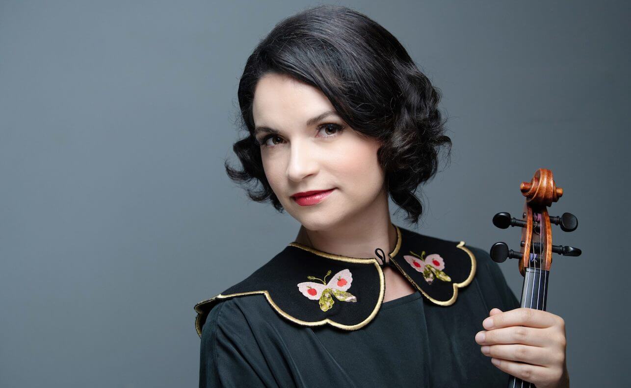 Marina Thibeault in a black dress with butterflies on the collar