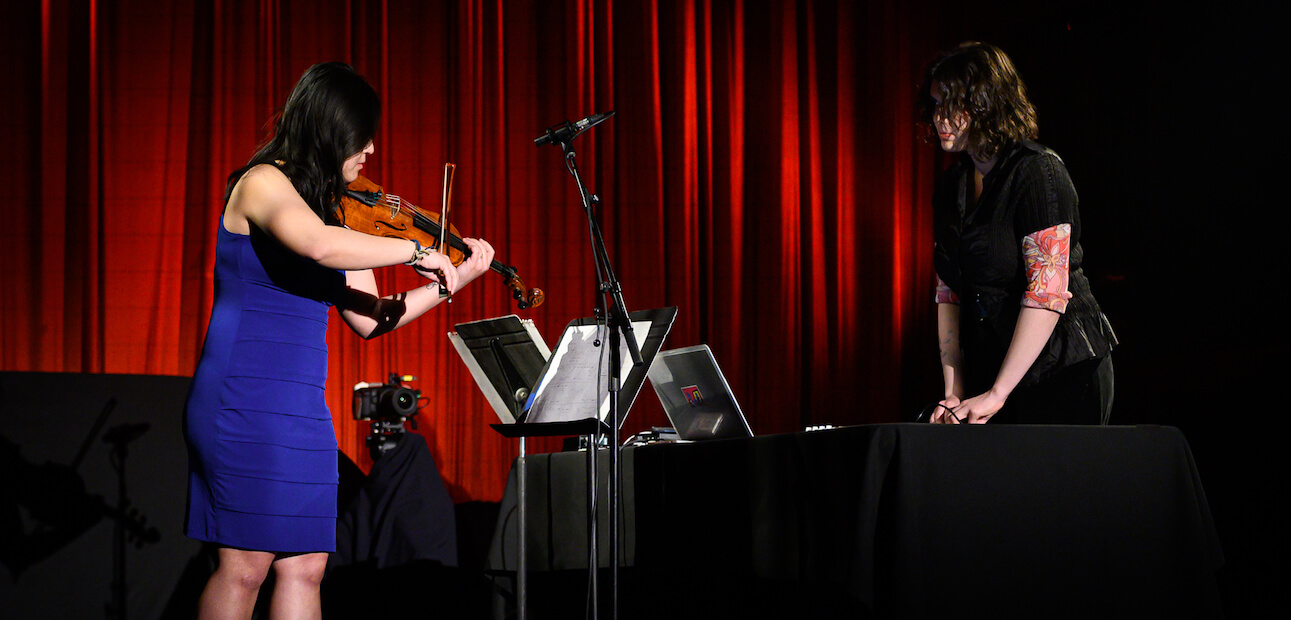 Sapphire Haze performing in front of a red curtain