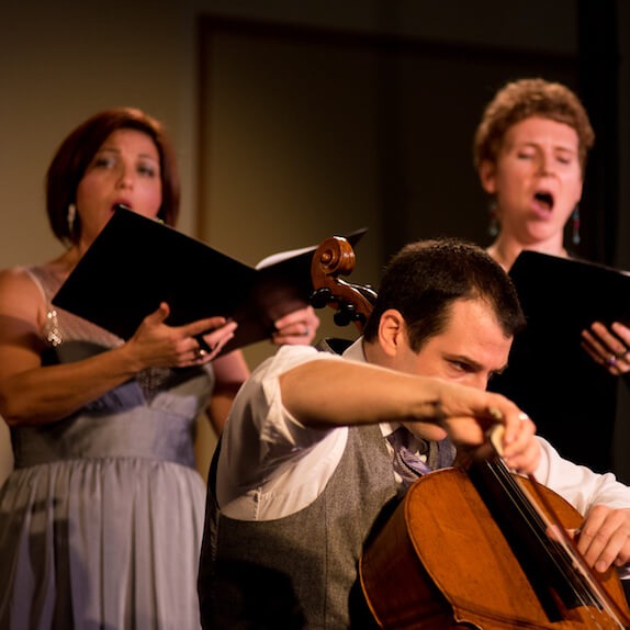 Stellaria singing behind Ariel Barnes, who is playing the cello