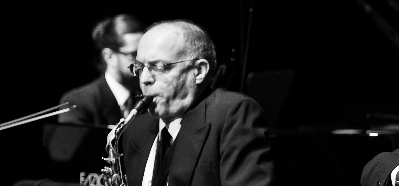 Yves Charuest playing saxophone on stage.